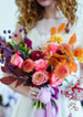 bride holding colorful boquet
