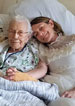 amanda in wedding dress in hospital bed with grandma