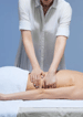 massage therapist massaging a person's back