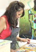 woman in apron painting